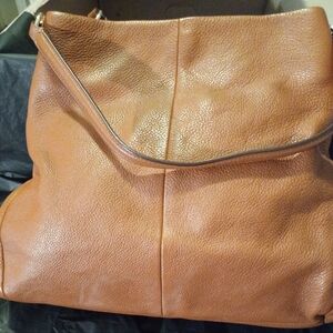 Elegant Tan Leather Coach Women's Bag With Gold Hardware.